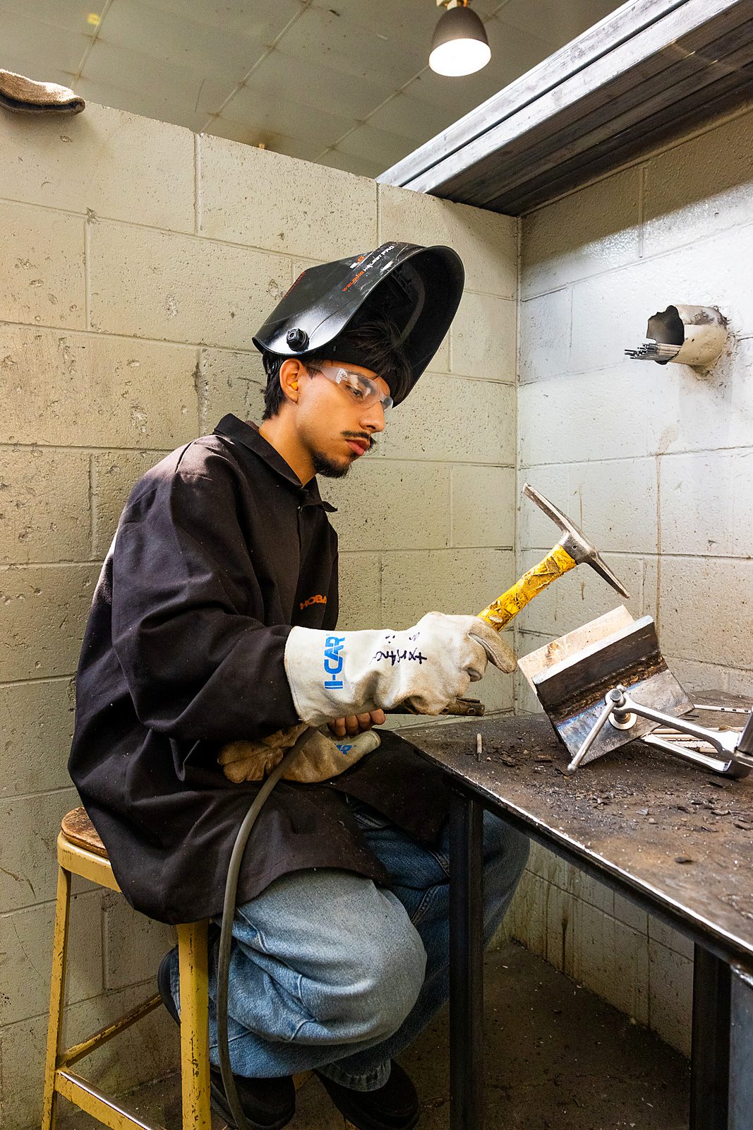 A student at a welding station